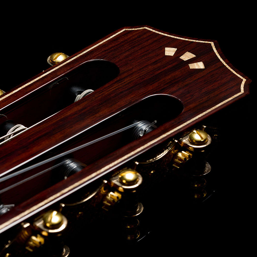 Close-up of Stage Artist Agave Burst headstock featuring a flamed maple Córdoba Arches logo thumb