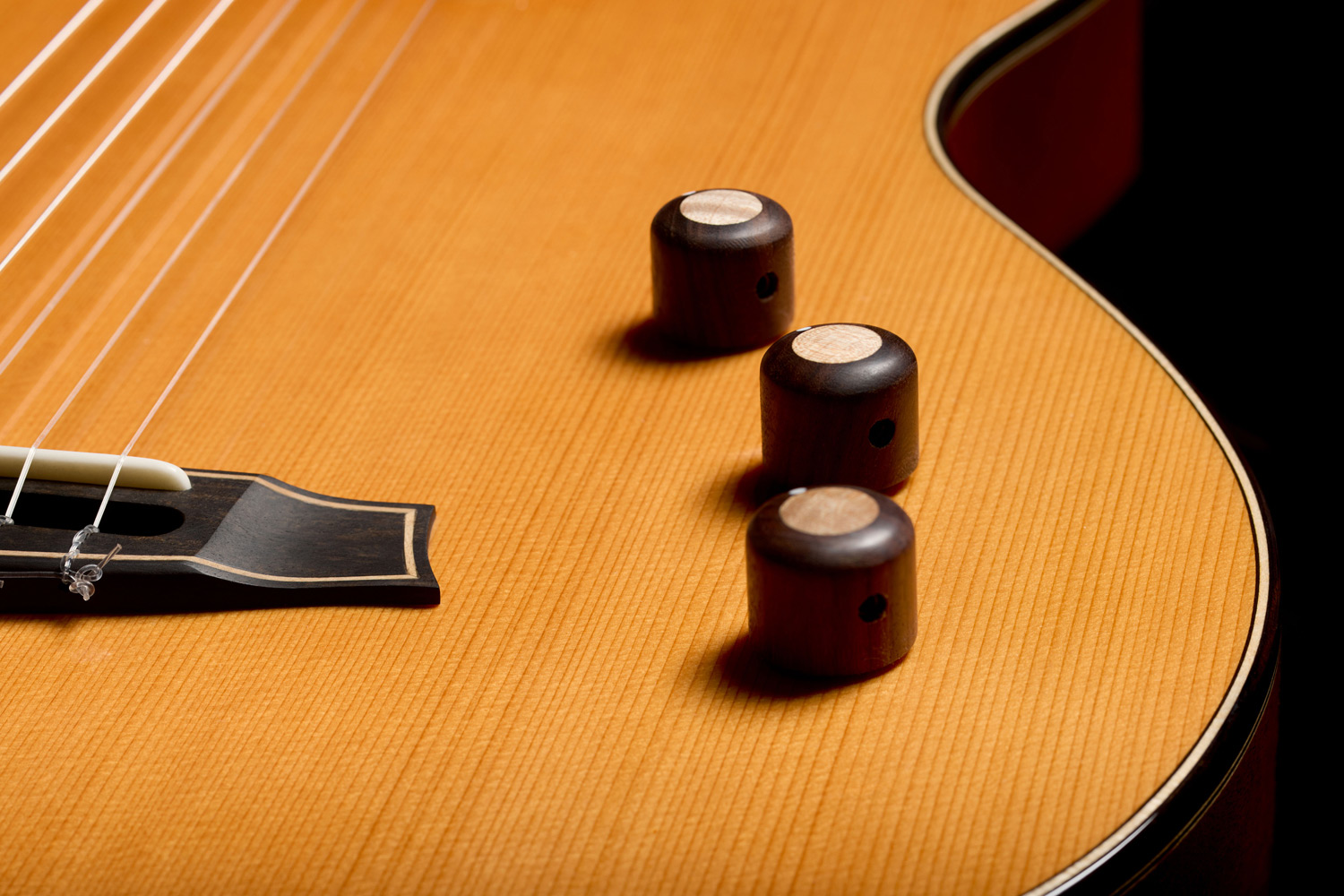 Close-up view of Stage Artist Traditional rosewood knobs inlaid with maple