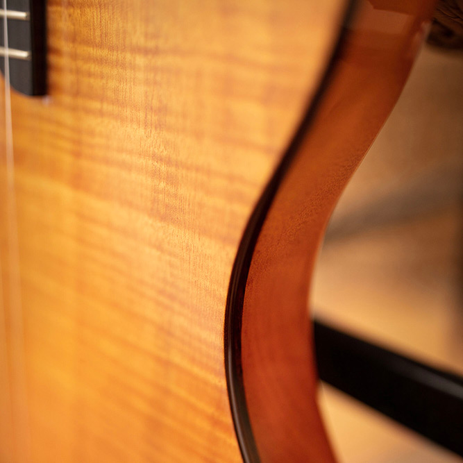Close-up of Stage Natural Amber body curve thumb