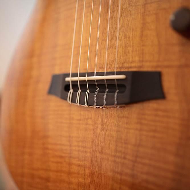 Close-up of Stage Natural Amber bridge thumb