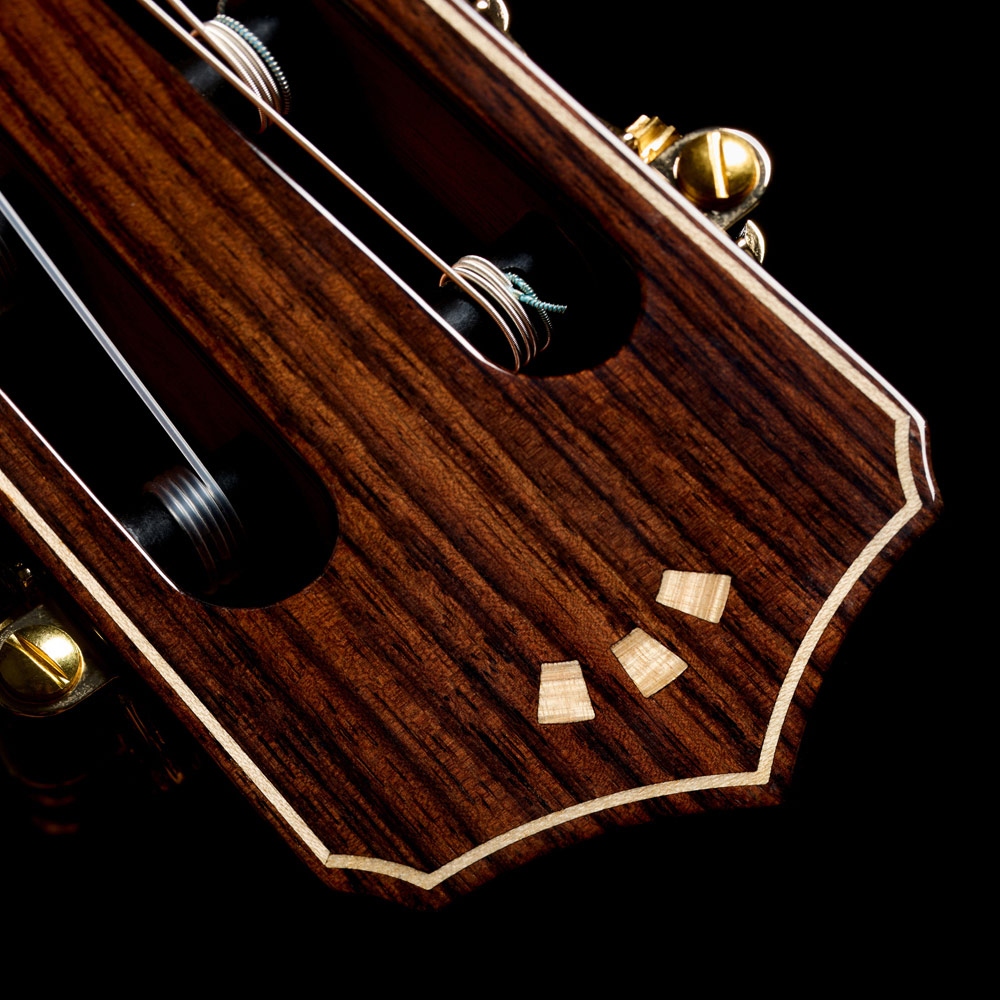 Close-up view of Stage Artist Habano Burst headstock featuring flamed maple Córdoba Arches logo thumb